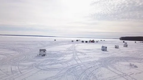 Flying back with a drone, moving away from the ice fishing village Stock-Footage 152422849