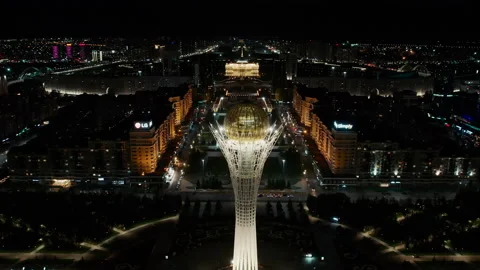 Flying back of light Bayterek and night Astana city panorama in Kazakhstan Stock Footage 234776877