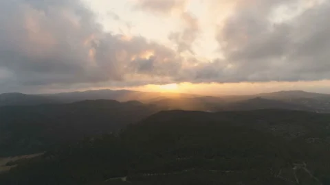 Flying back over mountains. Beautiful view of clouds and golden hour sunset Stock Footage 108106667