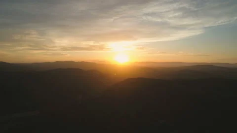 Flying back over mountains. Beautiful view of clouds and golden hour sunset Video stock 108107460