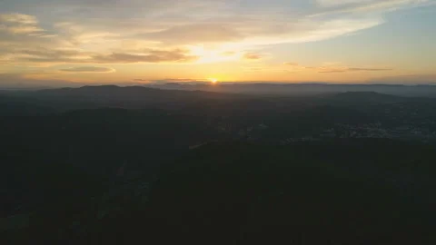 Flying back over mountains. Beautiful view of clouds and golden hour sunset Stock Footage 108107967