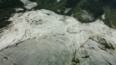 Flying back over Rock Face with reveal of Highway below, Aerial Drone Stock Footage 169558655