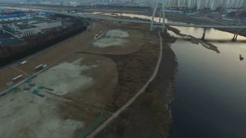 Flying backward over river and vacant field  Stock Footage 84288735
