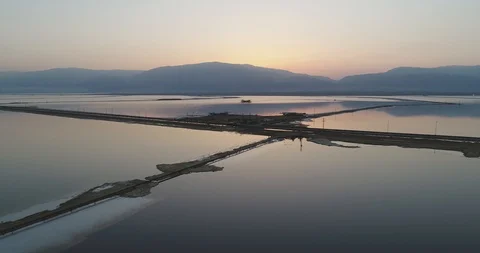 Flying backwards above the Dead Sea at sunrise 4K Stock Footage 106342199