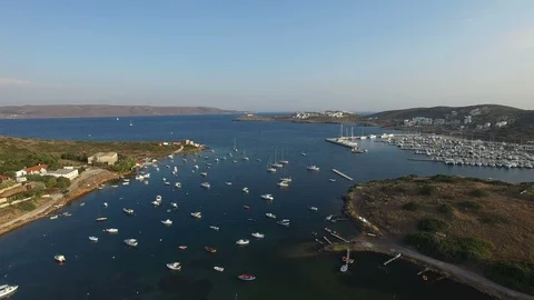Flying backwards above sea bay with yachts, sailing boats and catamarans. Stock Footage 87076185