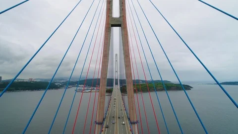 Flying backwards, aerial ascending view of cable-stayed Russian bridge across Stock-Footage 90084980