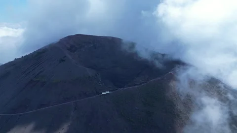 Flying backwards away from summit and crater of Mount Vesuvius volcano in Italy Stock Footage 328521601