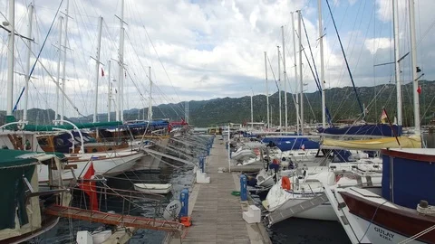 Flying backwards between the yachts in Kekova Bay marina. Turkey. DJI-0295-13 Stock Footage 102484209