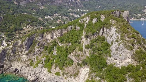Flying backwards from a Cliff in the water Aerial view Stock Footage 80314563