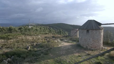Flying backwards close to several windmills on the top of the mountain Stock Footage 220378855