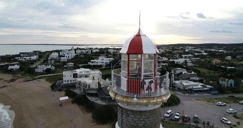 Flying backwards from detail of lighthouse top to panoramic view of village 스톡 동영상 119090744