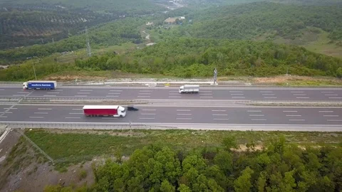 Flying backwards from forest to highway Stock Footage 102593061
