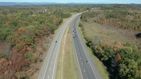Flying backwards high over interstate highway 87 in upstate New York Stock Footage 117276754