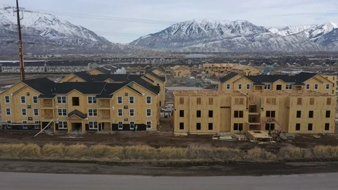 Flying backwards from new housing development over lake in winter Stock Footage 123166515