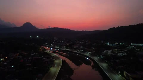 Flying backwards at night over the parrot river with the red sky reflecting in Stock-Footage 312026590