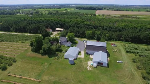 Flying backwards from orchard barn Stock Footage 90257069