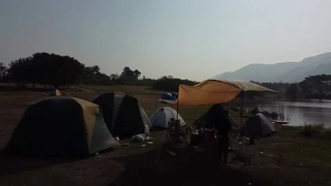 Flying backwards out from group of campers, Thailand Stockbeeldmateriaal 148847251