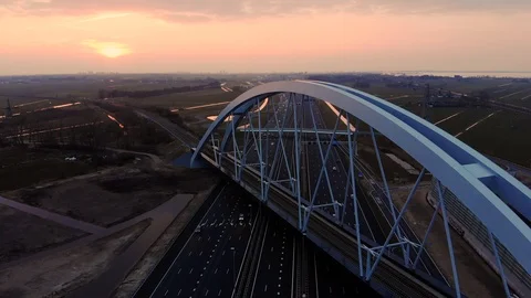 Flying backwards over busy highway with sunset 4K Stock Footage 87719225
