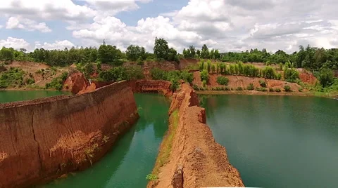 Flying Backwards Over a Canyon Wall Looking at Green Jungle Stock Footage 55289851