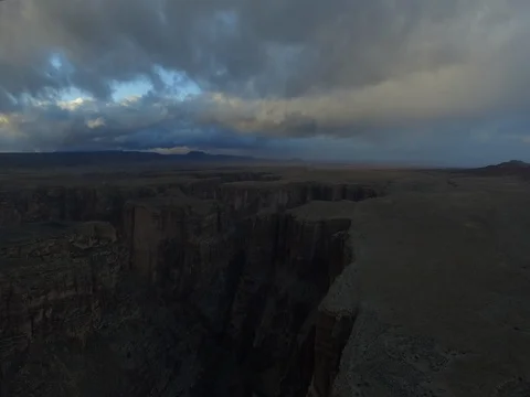 Flying backwards over a dark canyon Stock Footage 81044310