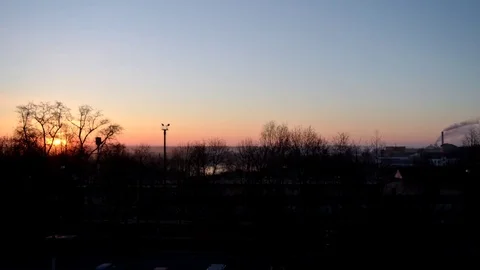 Flying backwards over downtown with cityscape views at sunrise 動画素材 75036784
