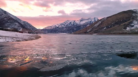 Flying backwards over ice and water on reservoir in Utah in winter Stock Footage 146901689