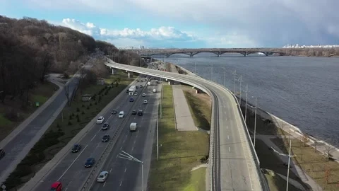 Flying backwards over the Kyiv interchange with a view of the metro bridge and Stock Footage 219744121