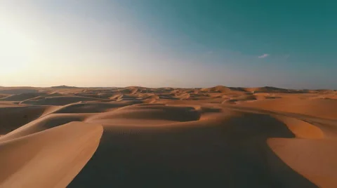 Flying backwards over picturesque sand dunes in the Arabian desert Stock Footage