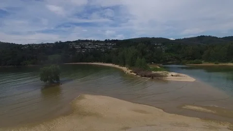 Flying backwards over river outlet Stock Footage 80371475
