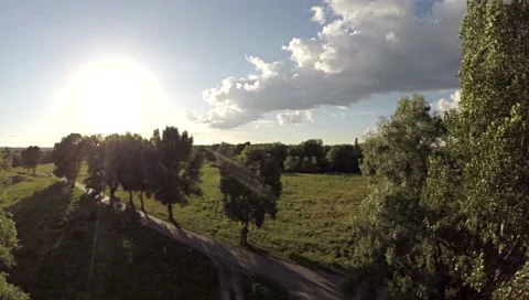 Flying backwards over road in fields. Stock Footage 45601235