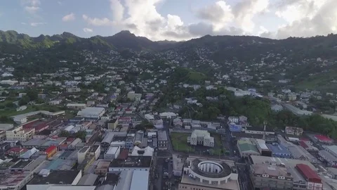 Flying backwards over a small town, Kingstown revealing the town/city Stock Footage 79888159