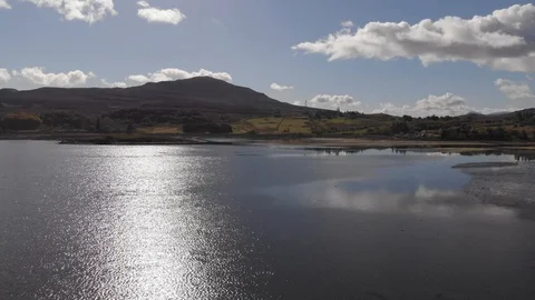 Flying Backwards Over Sun Glistening Loch Portree, Isle Of Skye, Aerial Cine D Stock Footage 108498016