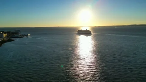 Flying backwards over the Tejo River at sunrise, capturing a cinematic view of 스톡 동영상 347981965