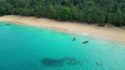 Flying backwards over the transparent sea, revealing the amazing boi beach and Stock Footage 312671012