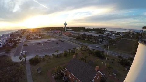 Flying backwards past a lighthouse with the sunset in the background. Stock Footage 90559831