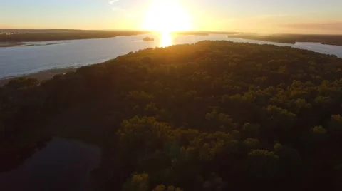 Flying backwards, from the setting sun Video stock 67380866