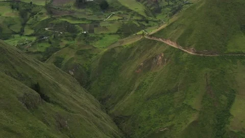 Flying backwards to show the area of a valley with meadows and houses Stock Footage 142746972