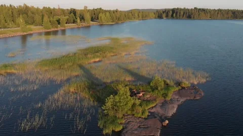 Flying backwards of a skerry over lake Stock Footage 134801282