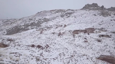 Flying backwards from a snowy hill Stock Footage 102591570