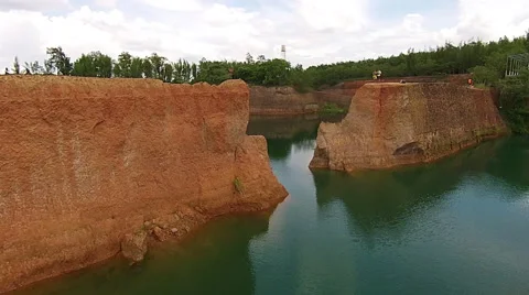 Flying Backwards Through Openings in Canyon Walls Over Water Stock Footage 55294638
