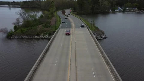 Flying backwards  with traffic over bridge Video stock 237945395