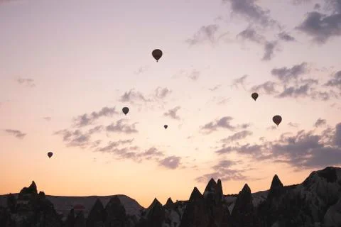 Flying balloons against the background of the colored dawn sky Stock Photos