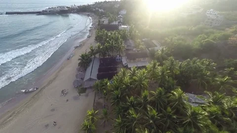 Flying on a beach town at sunset Video stock 78947259
