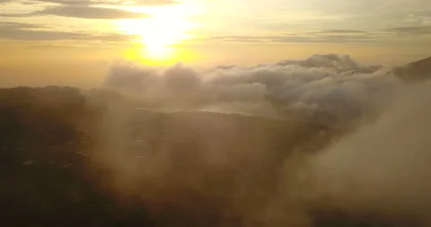 Flying in beautiful clouds. Aerial view of Bratan lake on sunrise in Bali Stock Footage 96903794