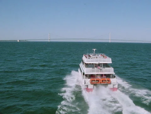 Flying behind ferry heading for bridge 1980s Stock Footage 136348601