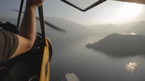 Flying behind the pilot in the floatplane over Lake como. Mountains, sun Stock Footage 127823128