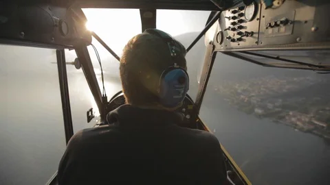 Flying behind the pilot in the floatplane over Lake como. Sun Video stock 127823135