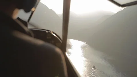 Flying behind the pilot in the floatplane over Lake como. Over the shoulder Video stock 127823150
