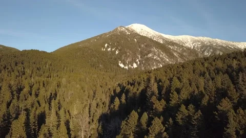 Flying below snow-capped mountain Stock Footage 166073467