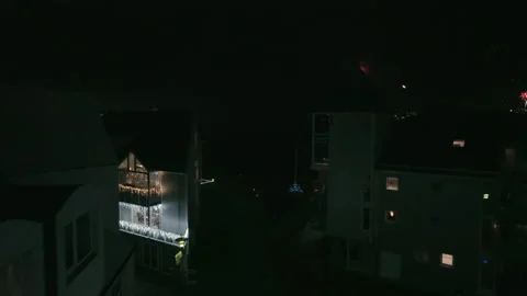 Flying in between buildings toward harbor and firework show. Stock Footage 228157896